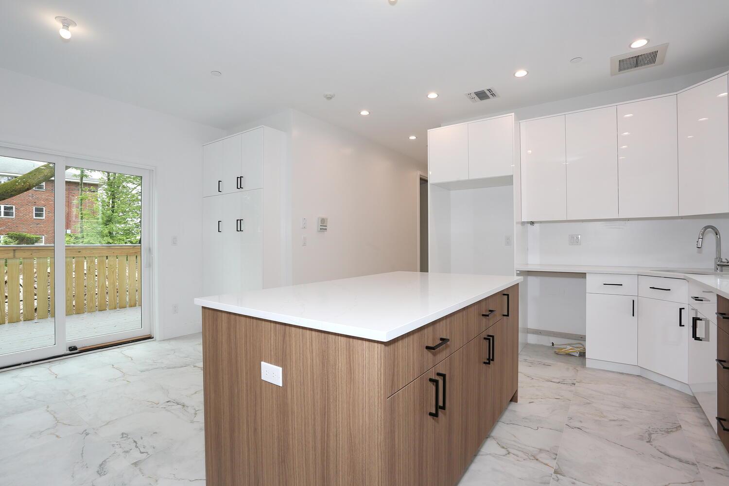 37 Ewing Avenue, Unit 202 Spring Valley, NY 10977 - Photo 10 of 44 a kitchen with a stove a refrigerator a sink dishwasher with a dining table and chairs