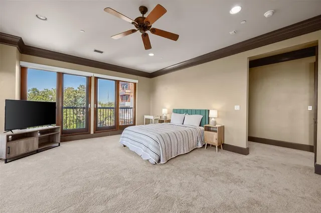 a spacious bedroom with a large bed and a flat screen tv