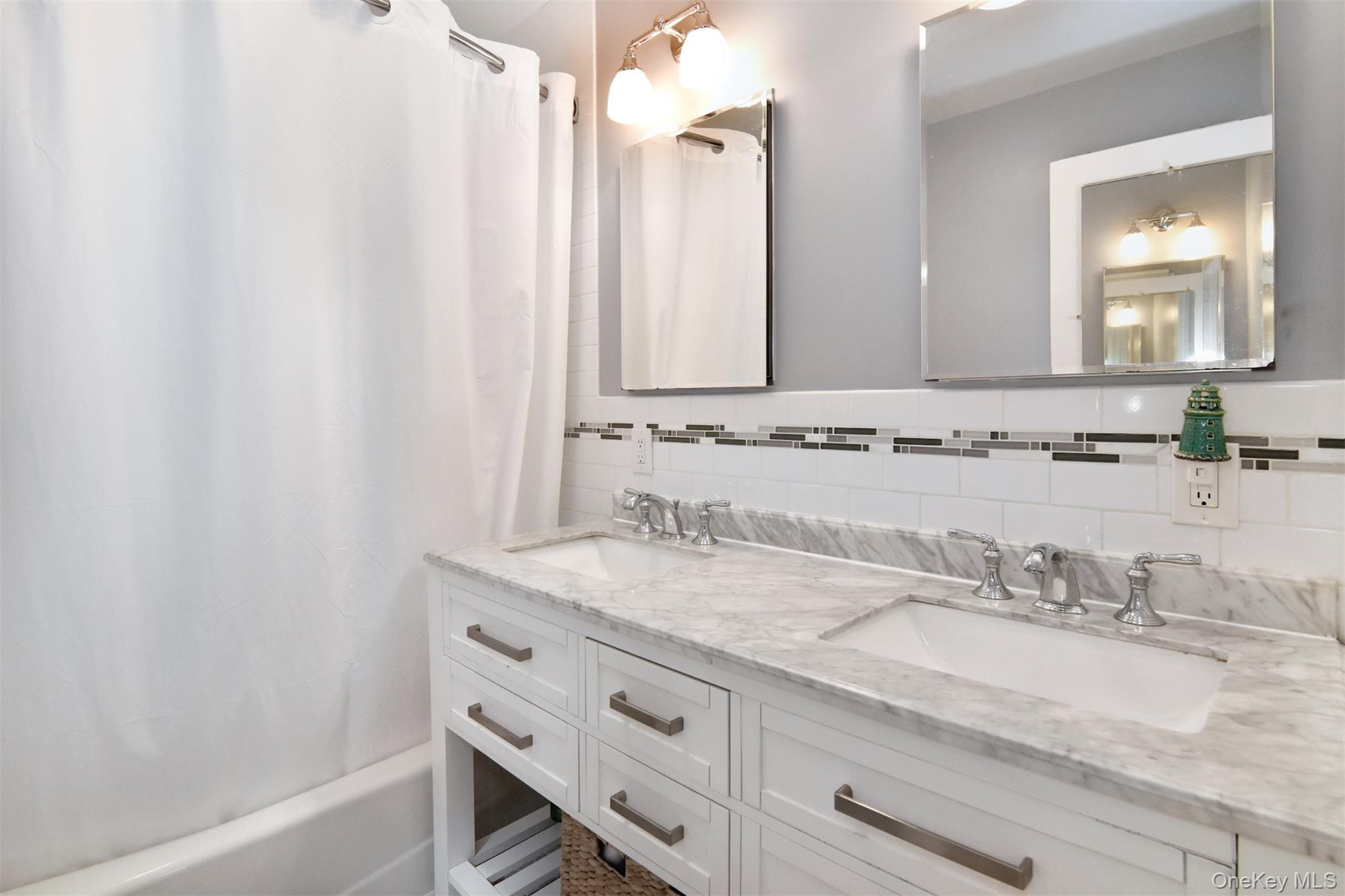 147 Midland Avenue Bronxville, NY 10708 - Photo 12 of 25 a bathroom with a granite countertop sink and a mirror