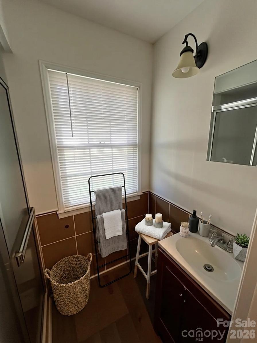 2545 Cedarwild Road Charlotte, NC 28212 - Photo 20 of 25 a bathroom with a sink and a mirror