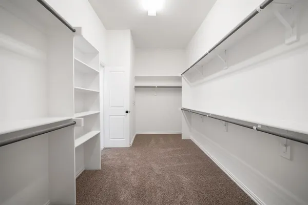 a bedroom with bed couch and window