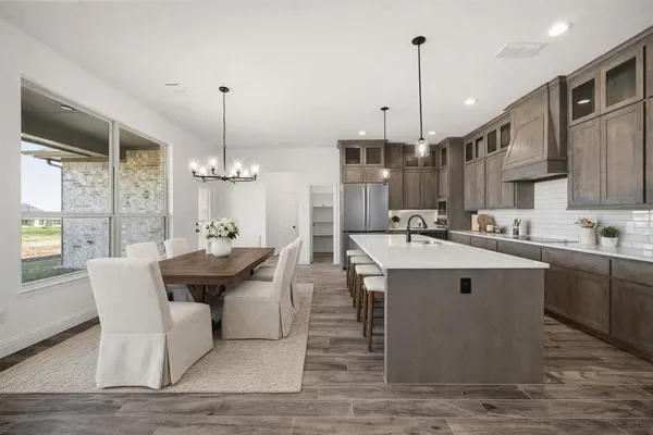 a kitchen island with stainless steel appliances kitchen island granite countertop a sink and cabinets