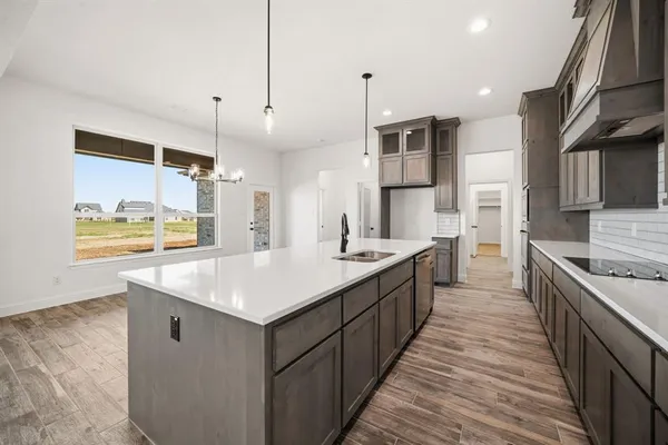 a large kitchen with stainless steel appliances kitchen island a large counter top and a stove