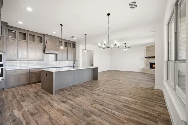 a large kitchen with kitchen island a sink stainless steel appliances and cabinets