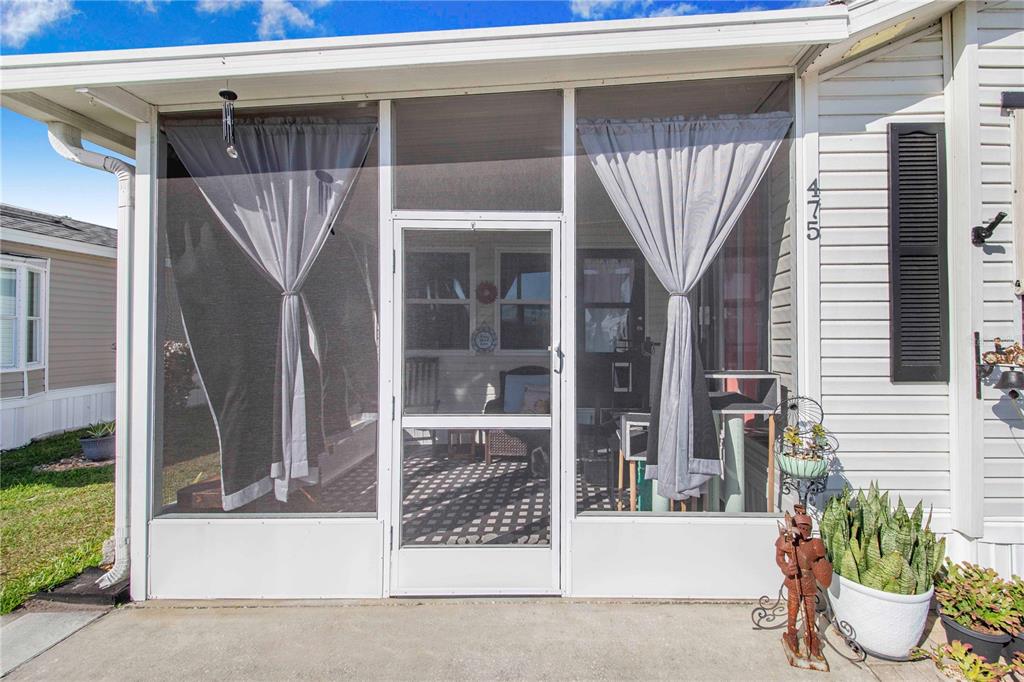 475 Pine Loop Frostproof, FL 33843 - Photo 7 of 40 a view of a porch with a potted plant and a window