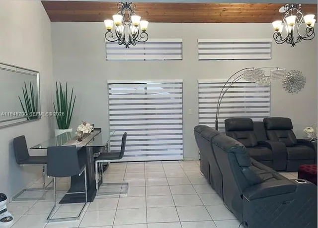 a view of a dining room with furniture and chandelier