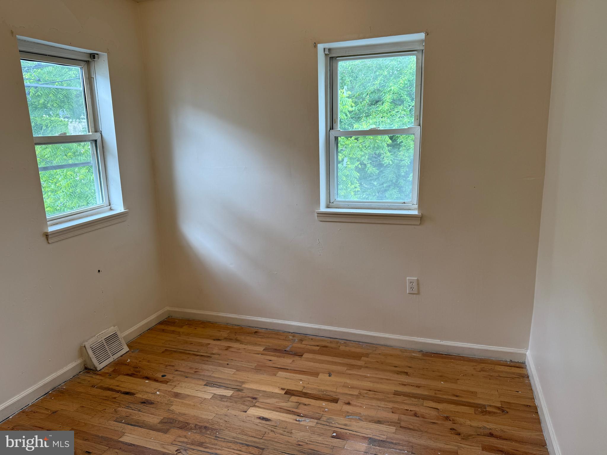 1016 Potter Street Chester, PA 19013 - Photo 12 of 22 a view of an empty room with wooden floor and a window
