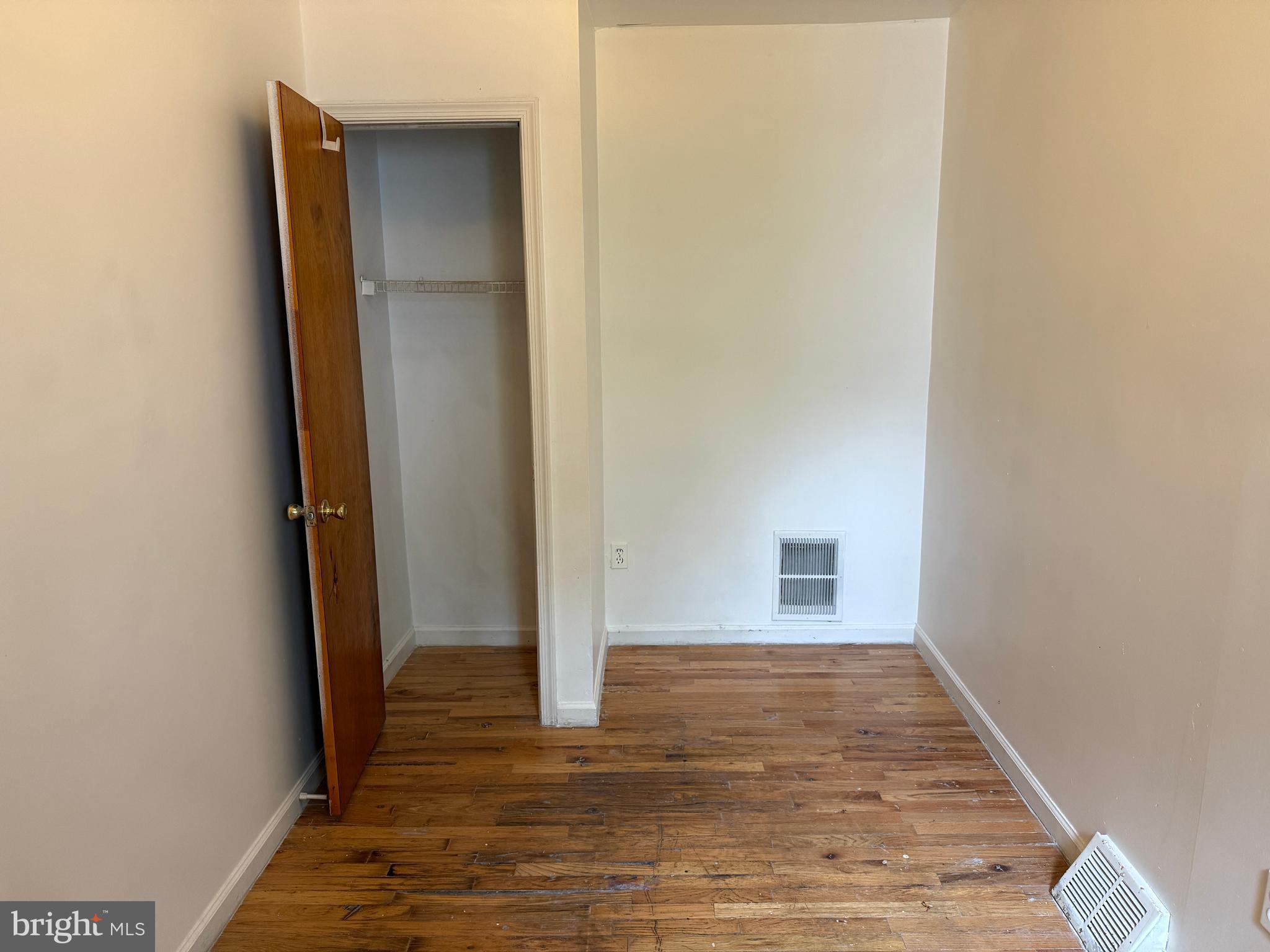 1016 Potter Street Chester, PA 19013 - Photo 15 of 22 an empty room with wooden floor and entrance