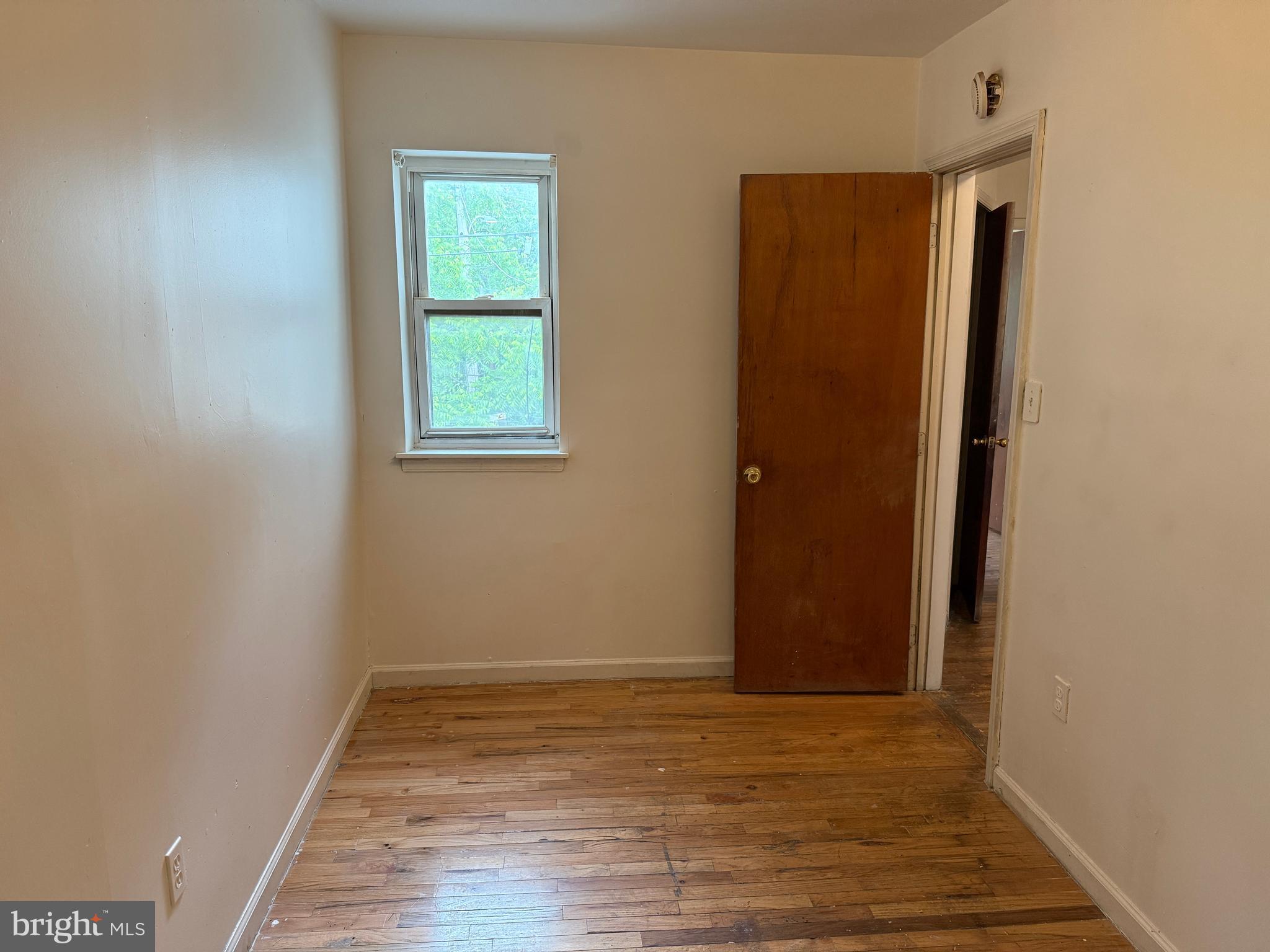 1016 Potter Street Chester, PA 19013 - Photo 17 of 22 an empty room with wooden floor and windows