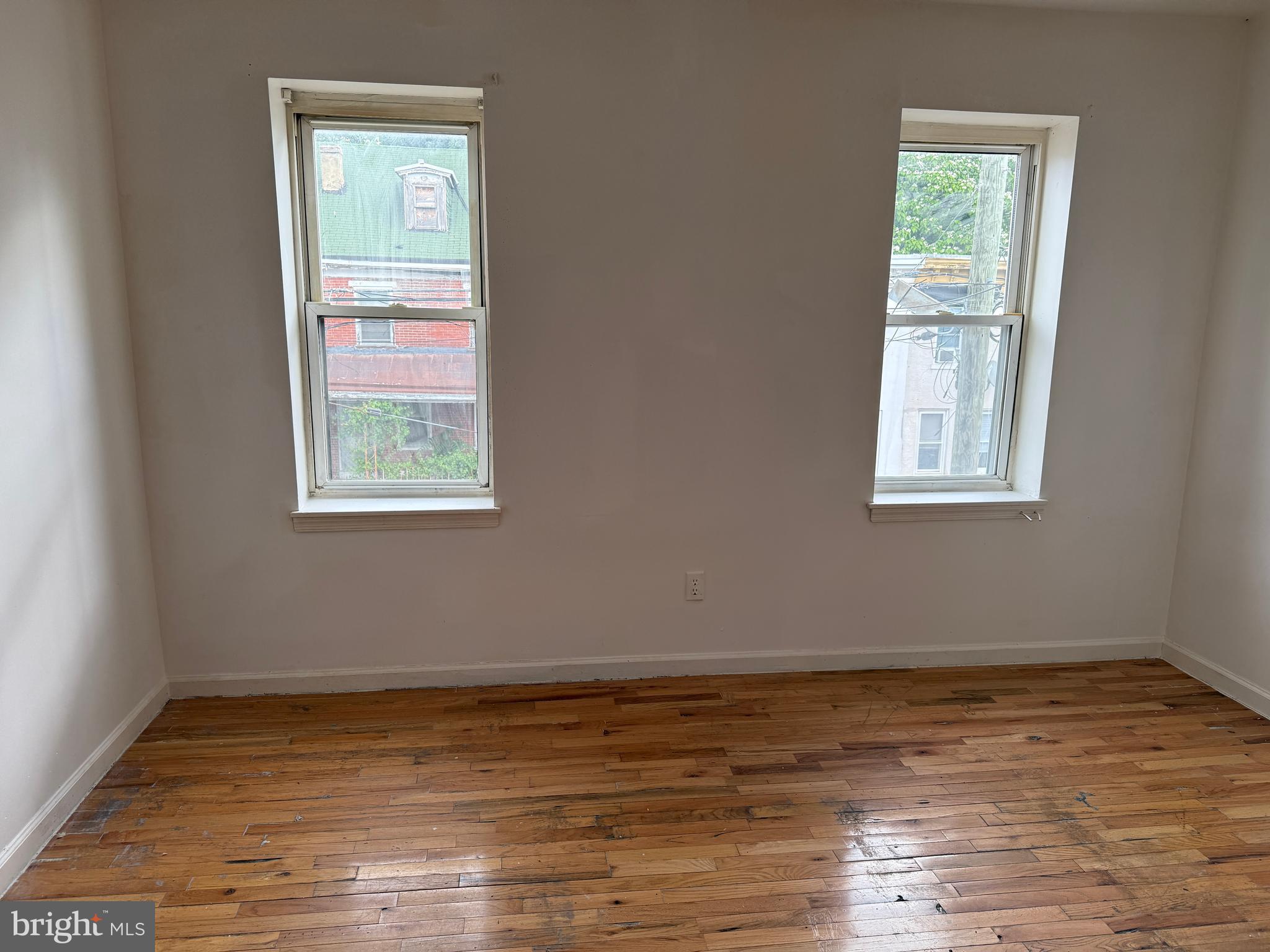 1016 Potter Street Chester, PA 19013 - Photo 18 of 22 a view of an empty room with wooden floor and a window