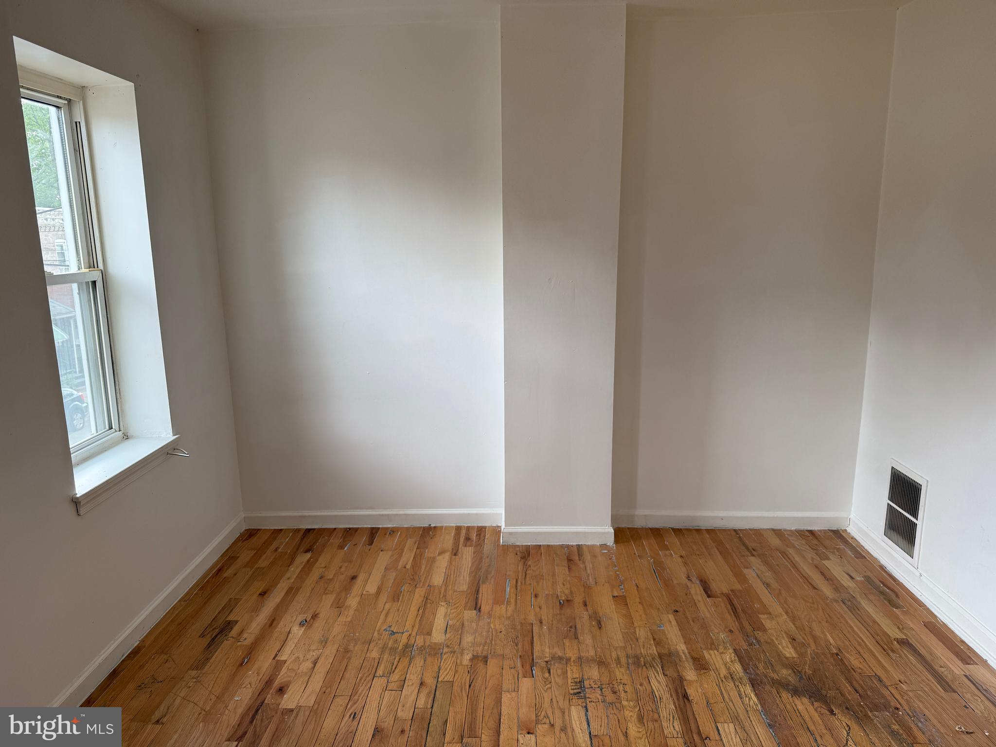 1016 Potter Street Chester, PA 19013 - Photo 19 of 22 an empty room with wooden floor and windows