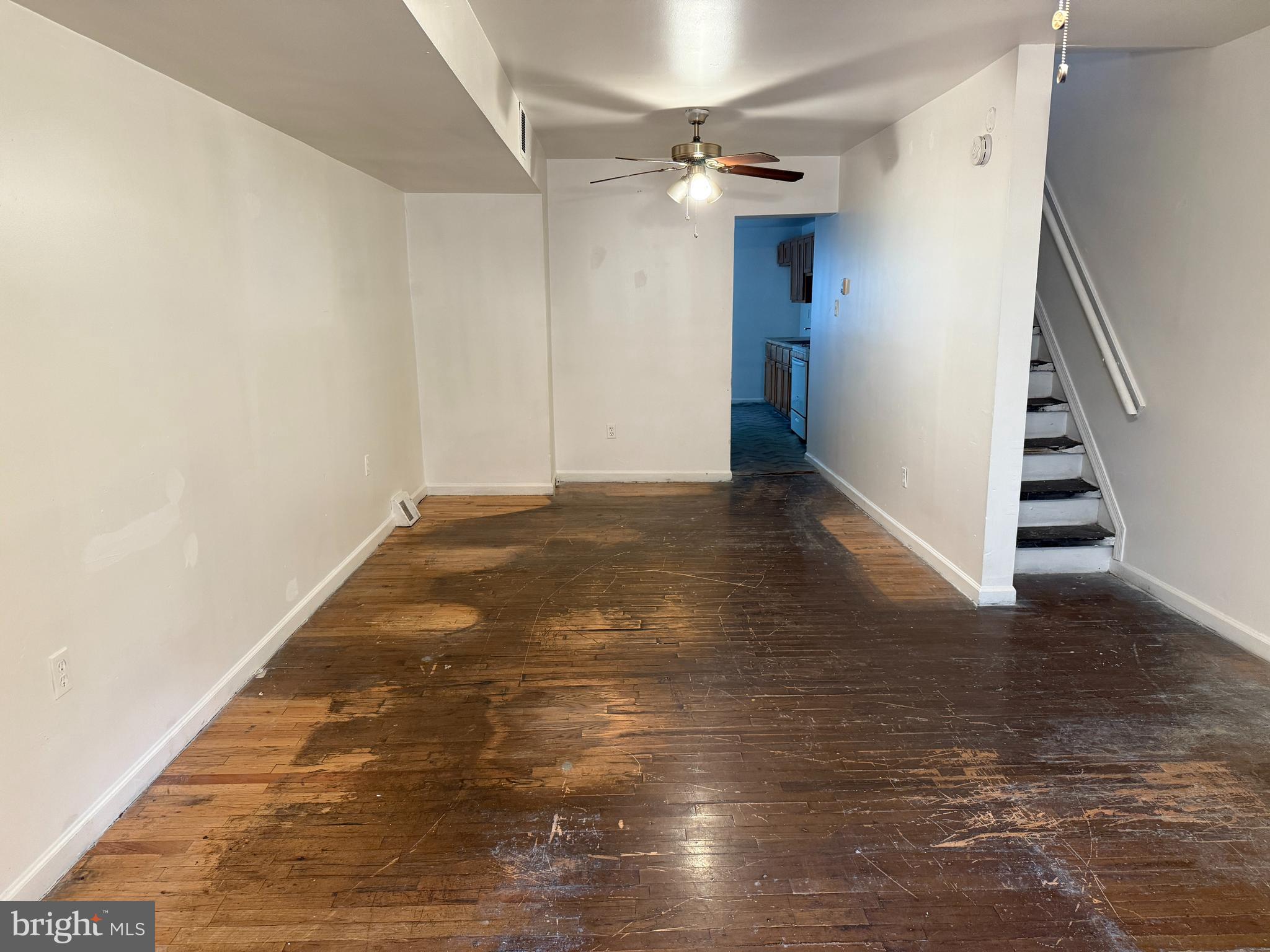 1016 Potter Street Chester, PA 19013 - Photo 2 of 22 a view of an empty room with wooden floor and stairs