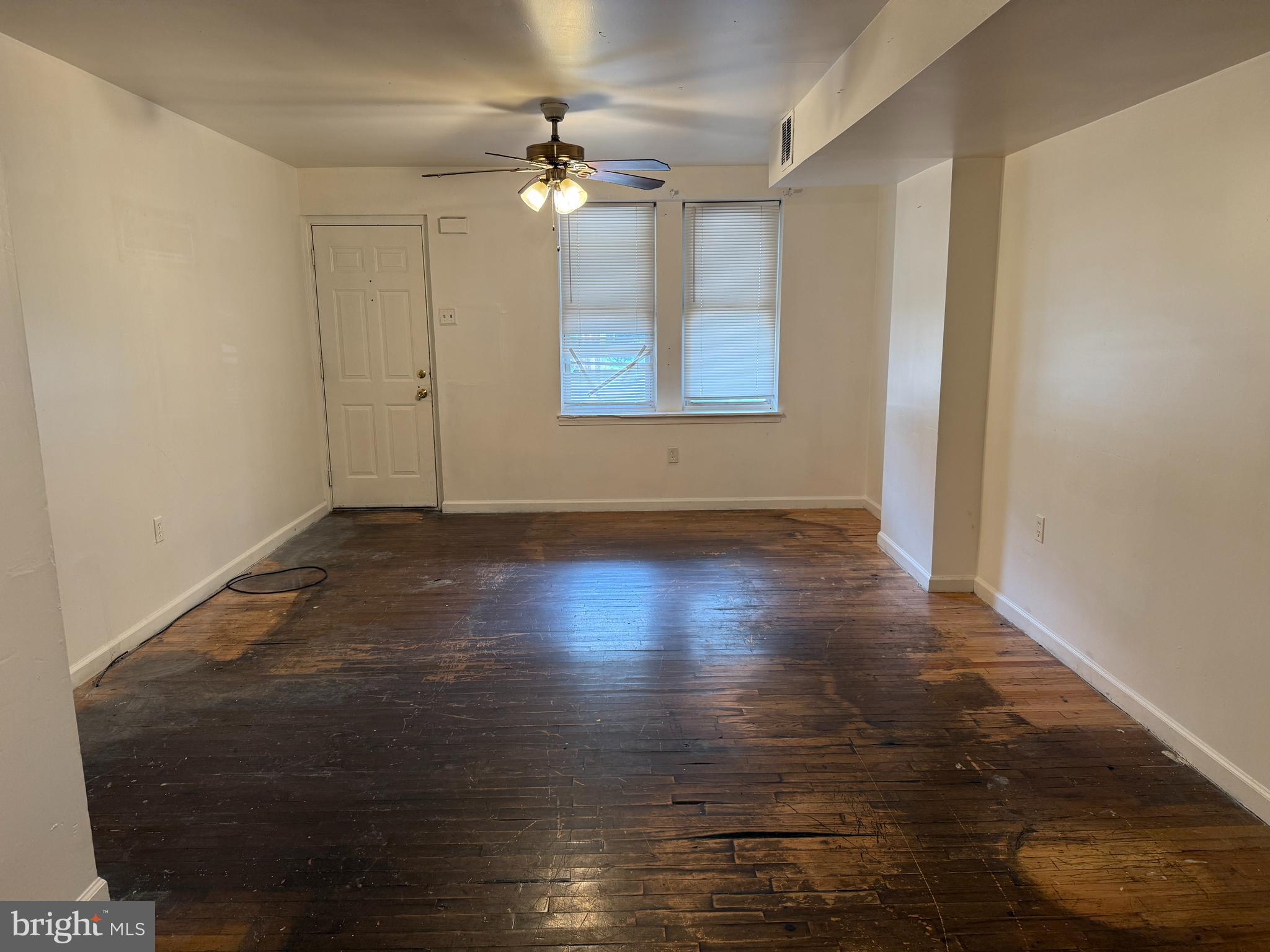 1016 Potter Street Chester, PA 19013 - Photo 4 of 22 a view of an empty room with wooden floor and a window