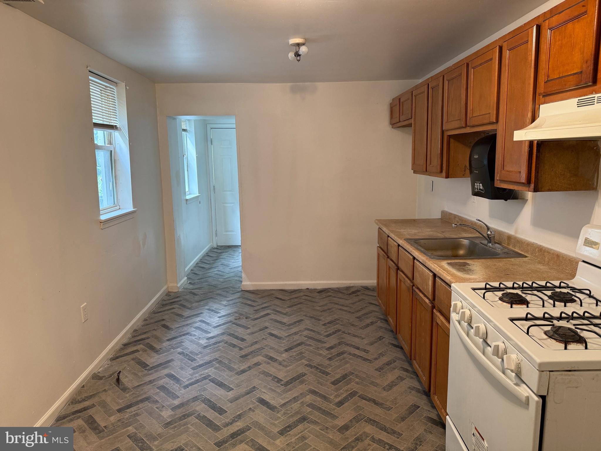 1016 Potter Street Chester, PA 19013 - Photo 5 of 22 a kitchen with granite countertop a sink stove and refrigerator