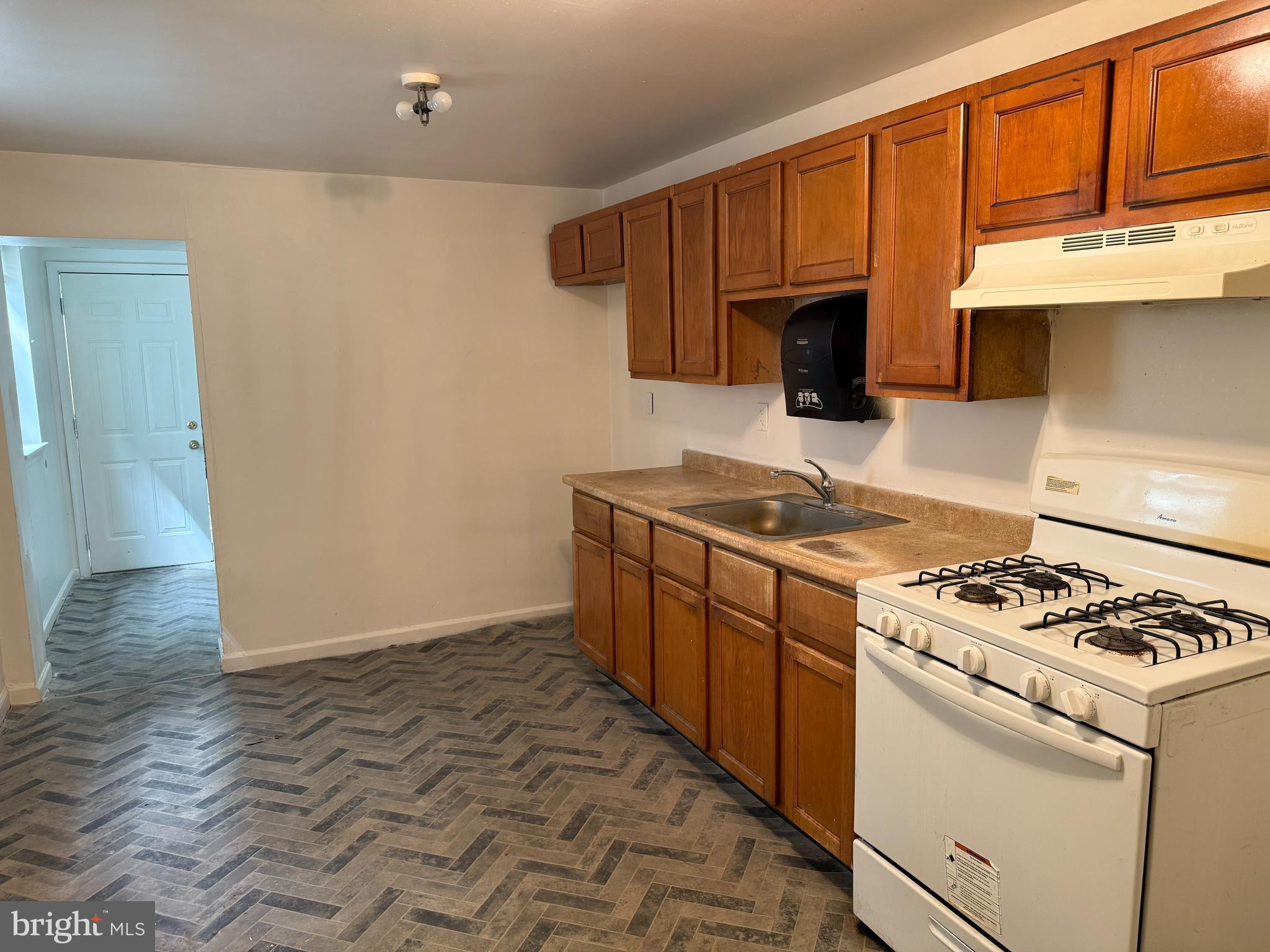 1016 Potter Street Chester, PA 19013 - Photo 6 of 22 a kitchen with stainless steel appliances granite countertop a stove and a refrigerator