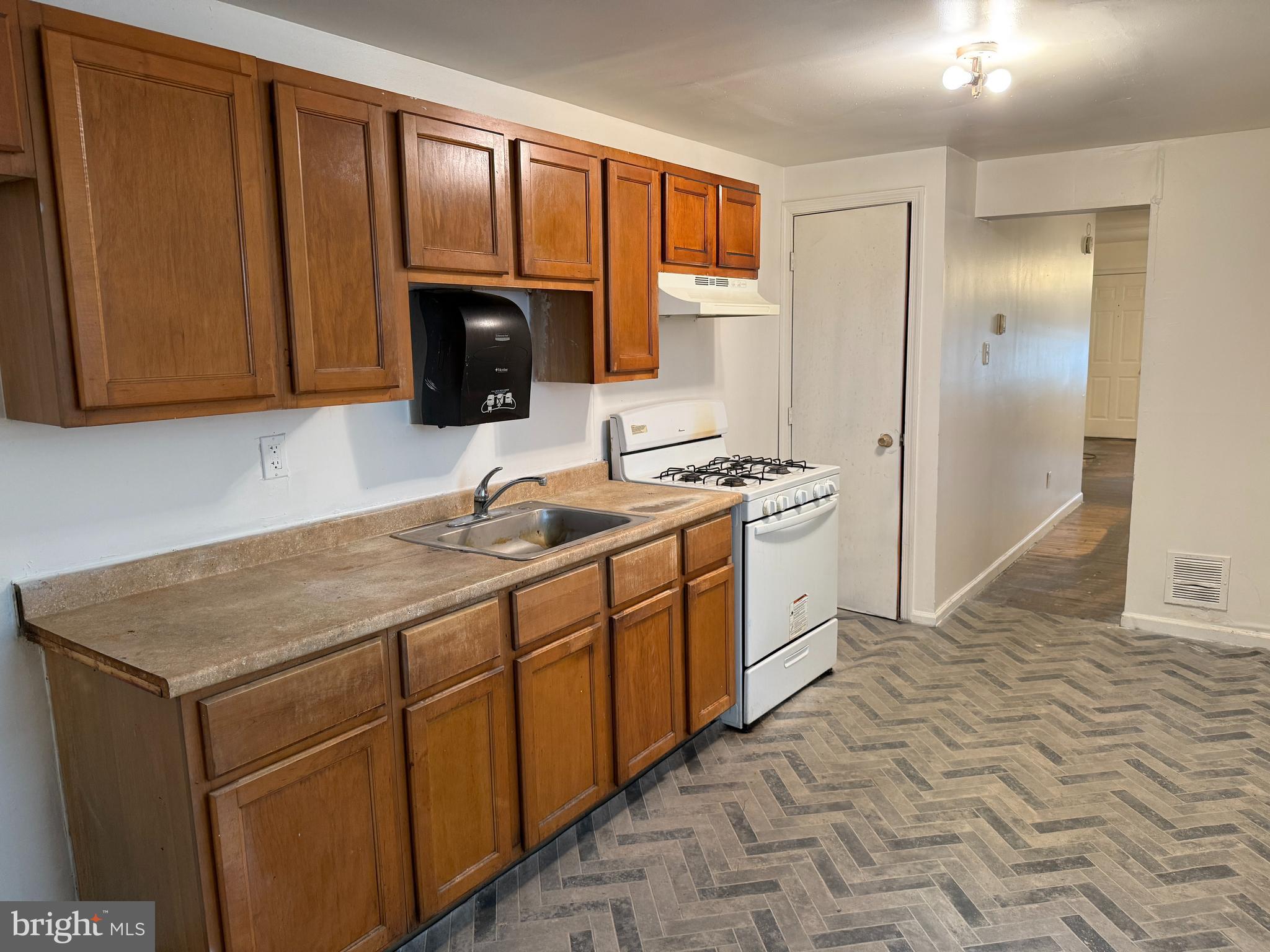 1016 Potter Street Chester, PA 19013 - Photo 8 of 22 a kitchen with stainless steel appliances granite countertop a sink stove and cabinets