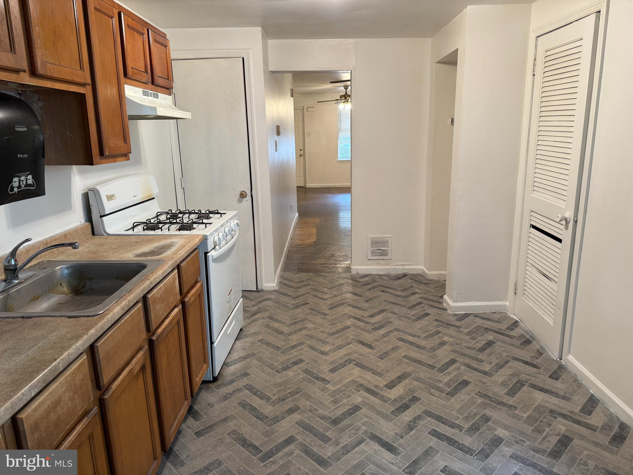 1016 Potter Street Chester, PA 19013 - Photo 9 of 22 a kitchen with a sink stove and refrigerator