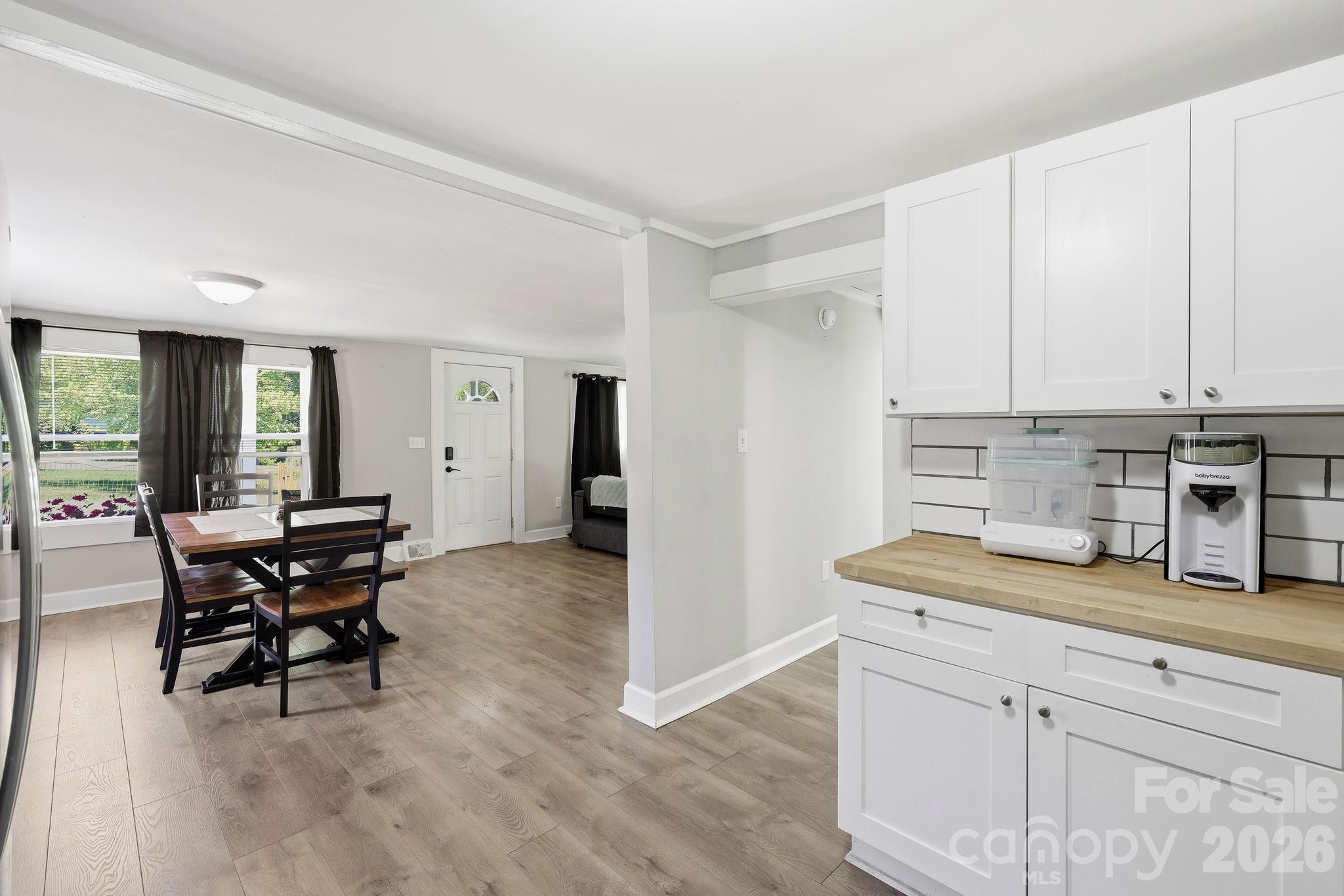 197 Mulberry Street Clyde, NC 28721 - Photo 11 of 31 a view of kitchen with kitchen island dining table and chairs