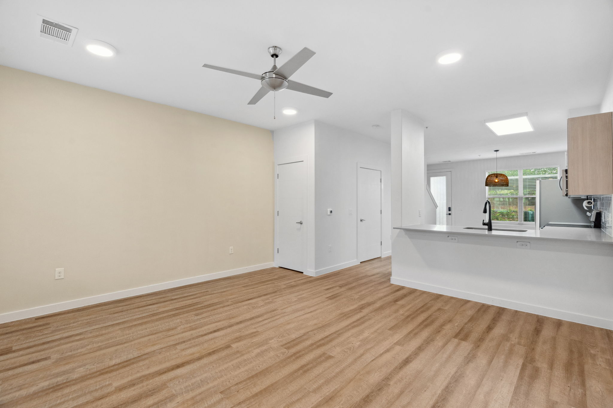 7805 Cooper Lane, Unit 606 Austin, TX 78745 - Photo 17 of 35 an empty room with wooden floor a ceiling fan and windows