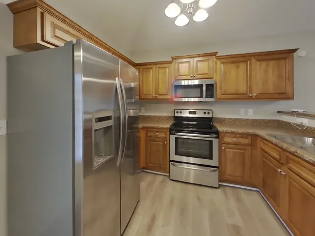 a kitchen with a refrigerator stove and sink