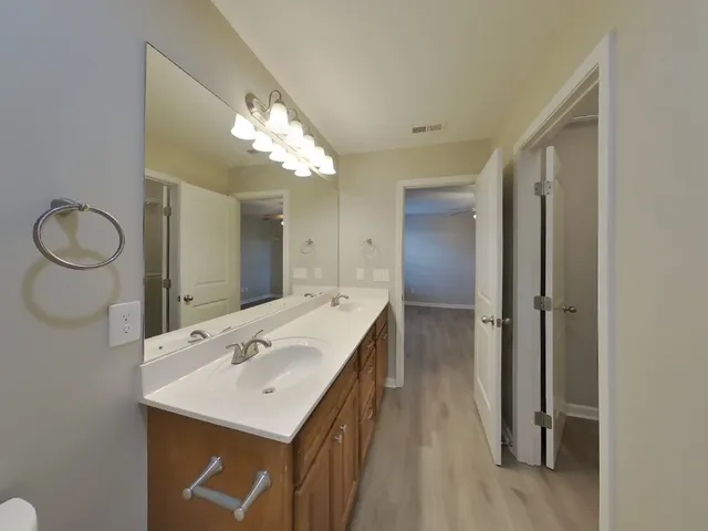 a bathroom with a sink vanity and mirror