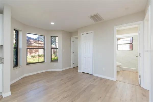 a view of an empty room with wooden floor