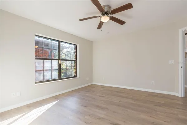 a view of a room with a window and a ceiling fan