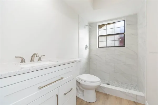 a living room with furniture and a ceiling fan