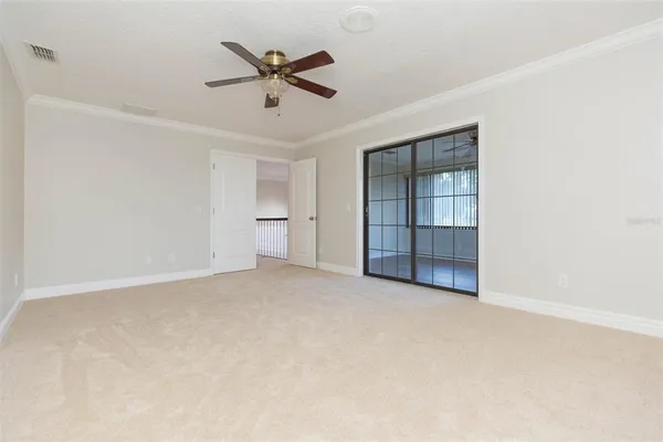 an empty room with closet and a ceiling fan
