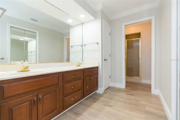 an empty room with windows and ceiling fan