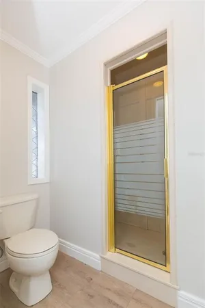 an empty room with windows and ceiling fan