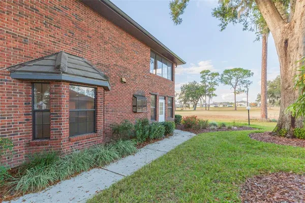 a front view of a house with a yard table and chairs