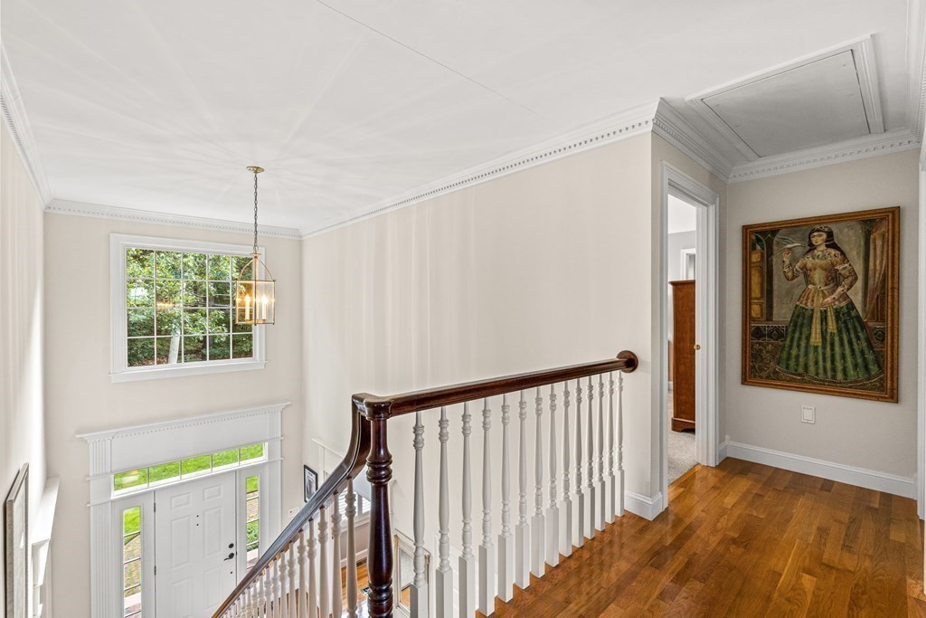 17 Crown Ridge Road Wellesley, MA 02482 - Photo 17 of 37 a view of a hallway with a window and stairs
