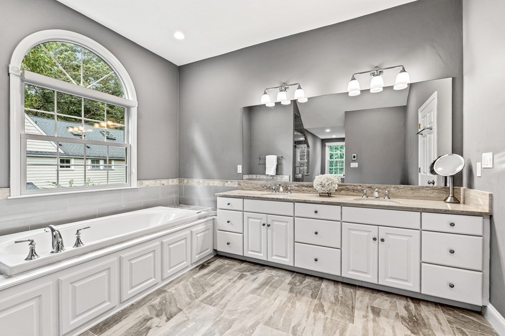 17 Crown Ridge Road Wellesley, MA 02482 - Photo 19 of 37 a spacious bathroom with double vanity a mirror a bathtub and double vanity