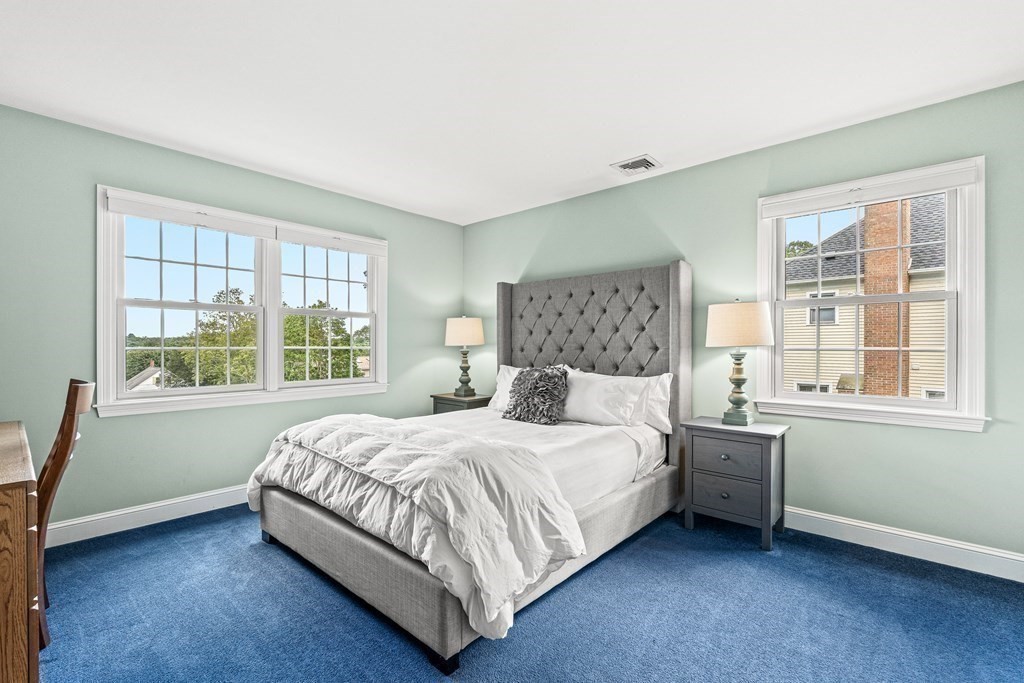 17 Crown Ridge Road Wellesley, MA 02482 - Photo 22 of 37 a bedroom with a bed lamp and window