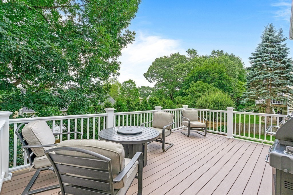17 Crown Ridge Road Wellesley, MA 02482 - Photo 27 of 37 a view of a deck with two chairs and a table