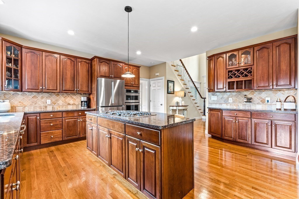 17 Crown Ridge Road Wellesley, MA 02482 - Photo 4 of 37 a kitchen with stainless steel appliances granite countertop a sink stove cabinets and wooden floor