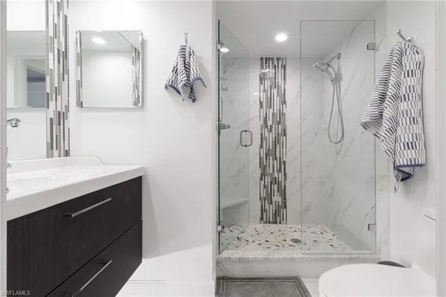 a bathroom with a sink toilet and shower