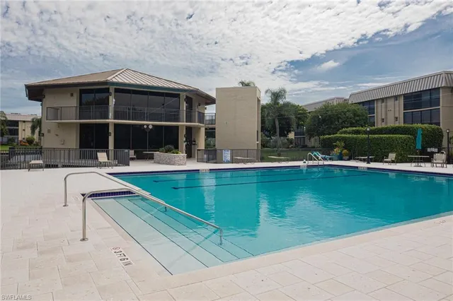 a swimming pool with outdoor seating and yard