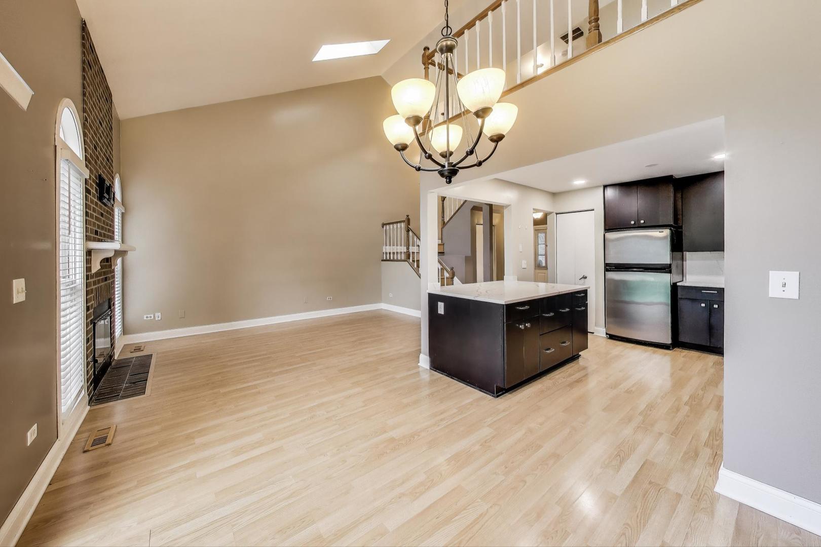 1905 Stillwater Road Arlington Heights, IL 60004 - Photo 11 of 36 a kitchen with stainless steel appliances granite countertop a stove and cabinets with wooden floor
