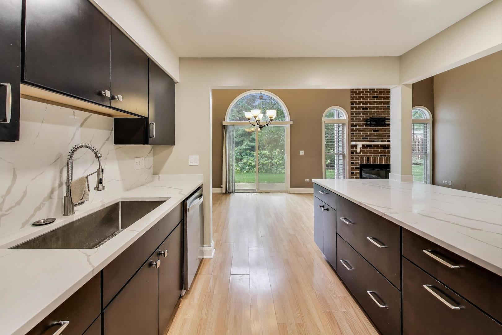 1905 Stillwater Road Arlington Heights, IL 60004 - Photo 13 of 36 a large kitchen with granite countertop a large counter top a sink a window and stainless steel appliances