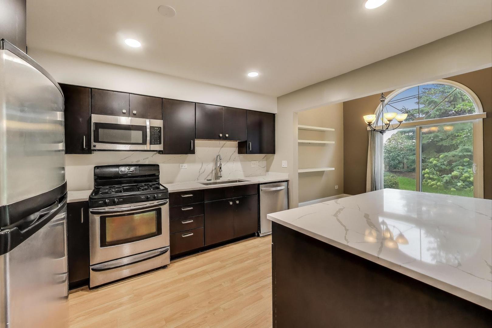 1905 Stillwater Road Arlington Heights, IL 60004 - Photo 14 of 36 a modern kitchen with stainless steel appliances and stove top oven