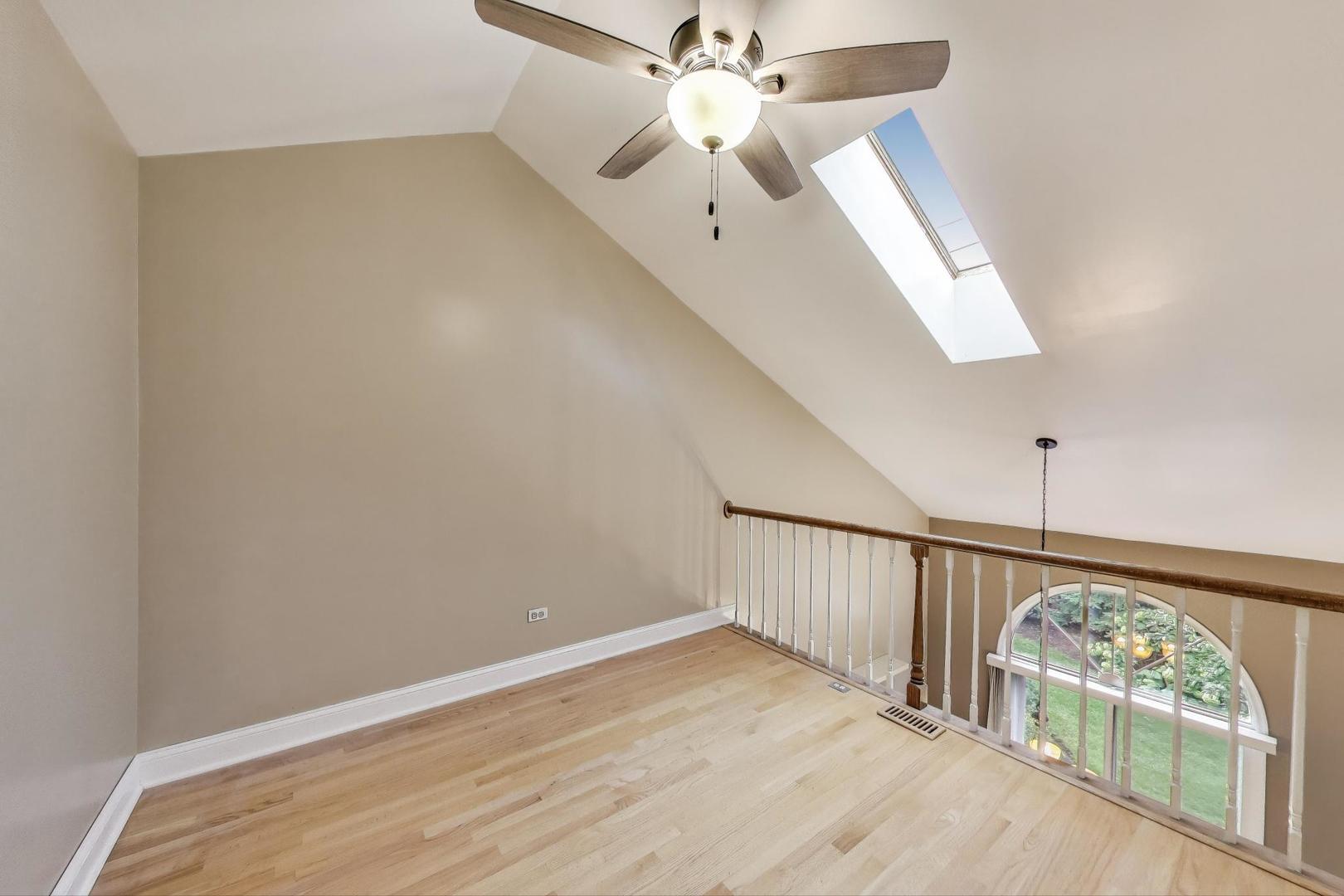 1905 Stillwater Road Arlington Heights, IL 60004 - Photo 17 of 36 an empty room with wooden floor fan and windows