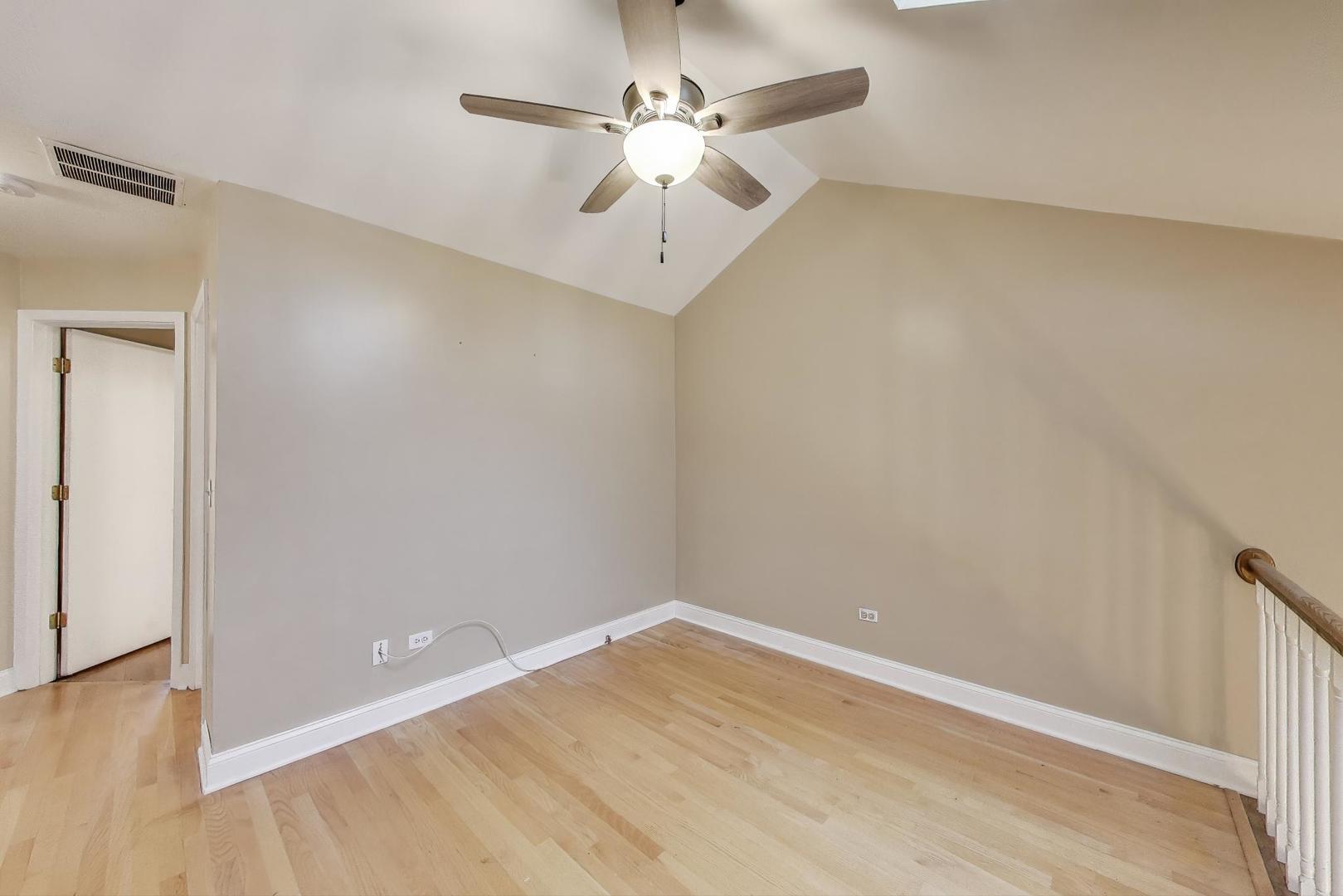 1905 Stillwater Road Arlington Heights, IL 60004 - Photo 18 of 36 an empty room with a ceiling fan and wooden floor