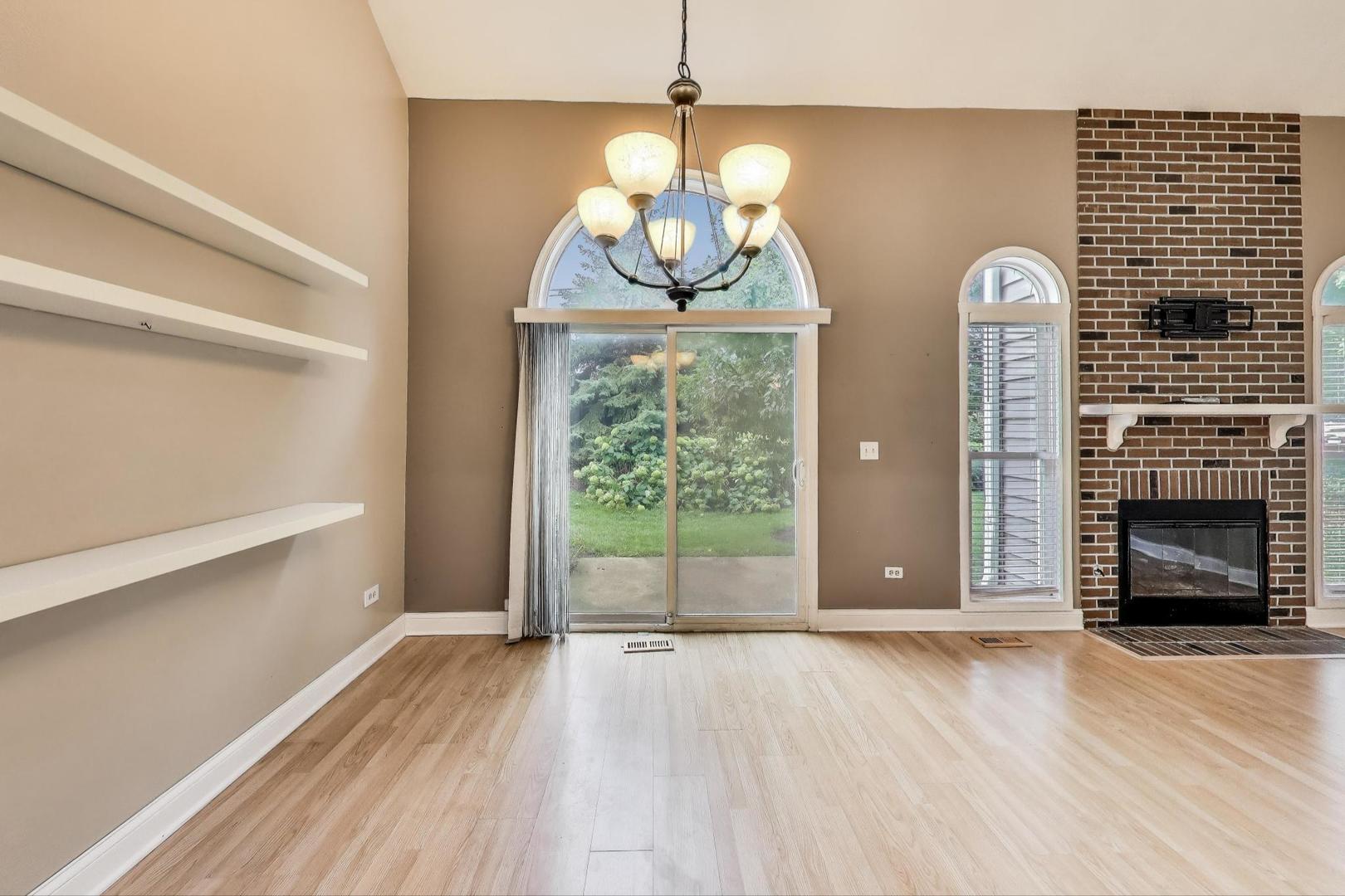 1905 Stillwater Road Arlington Heights, IL 60004 - Photo 10 of 36 a view of a livingroom with wooden floor and a fireplace