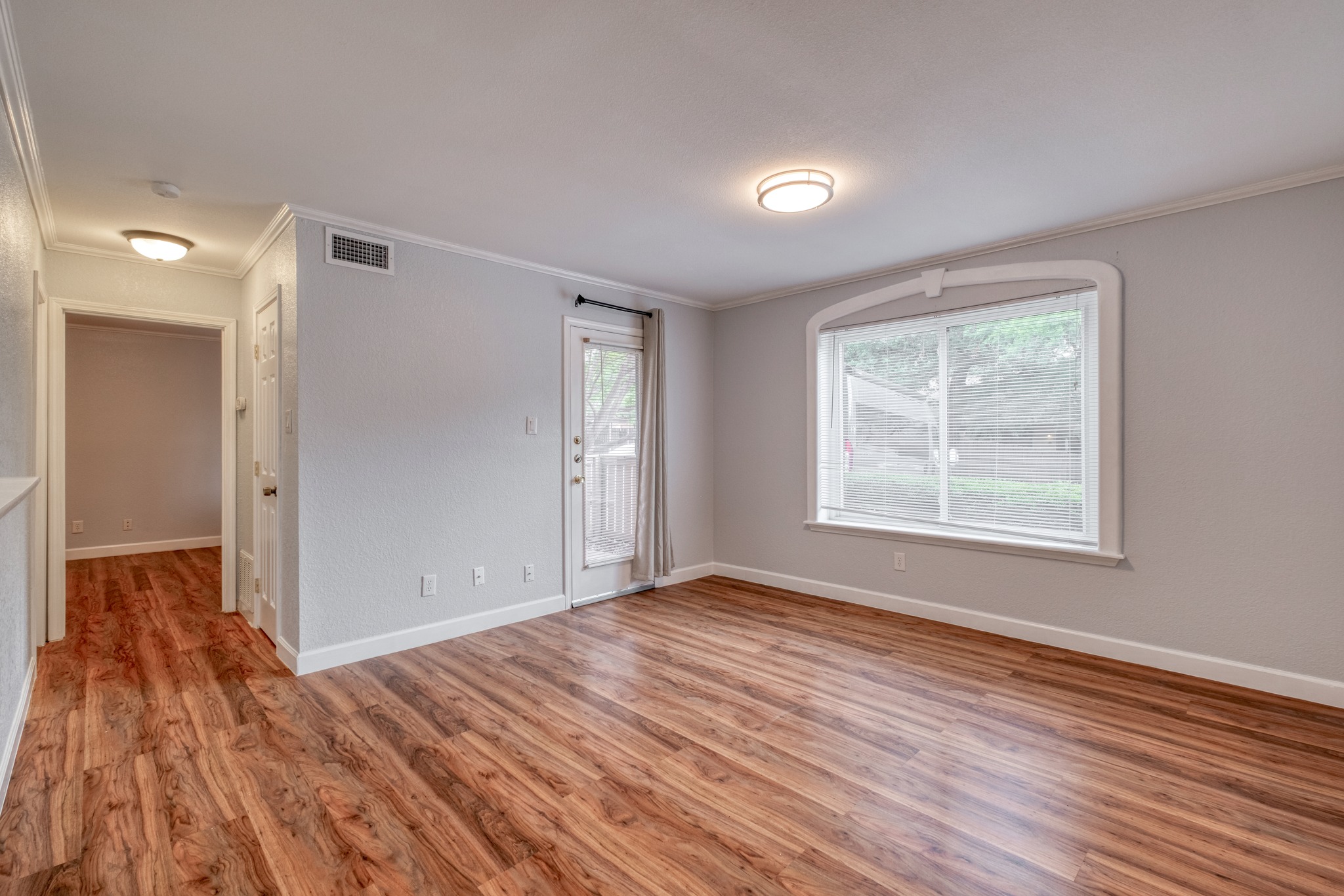 8210 Bent Tree Road, Unit 153 Austin, TX 78759 - Photo 7 of 20 a view of empty room with wooden floor and fan