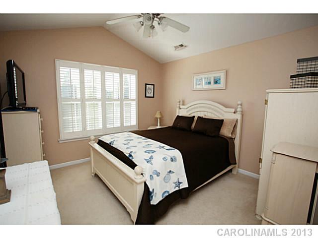 524 Bent Leaf Court Fort Mill, SC 29708 - Photo 12 of 16 a bedroom with a bed next to a window with a projector