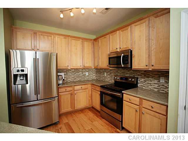 524 Bent Leaf Court Fort Mill, SC 29708 - Photo 4 of 16 a kitchen with stainless steel appliances granite countertop a refrigerator stove top oven and sink