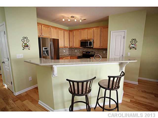 524 Bent Leaf Court Fort Mill, SC 29708 - Photo 5 of 16 a kitchen with stainless steel appliances a dining table chairs and a refrigerator
