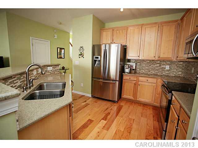 524 Bent Leaf Court Fort Mill, SC 29708 - Photo 6 of 16 a kitchen with granite countertop a sink wooden floor and stainless steel appliances